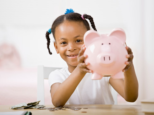 girl holding piggy bank